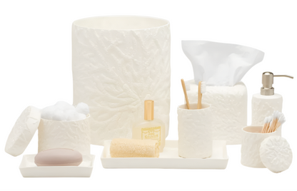 The Alanya White Bath Collection by Pigeon & Poodle showcases coral-patterned white porcelain accessories—waste bin, tissue box, containers, soap dish, toothbrush holder, lotion dispenser, and tray—on a white background.