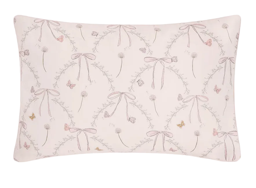 Introducing the Bows & Butterfly Kisses Bedding Collection by Gooselings—a rectangular pillow with a pale pink background adorned with a charming, repeating pattern of bows, butterflies, flowers, and leaves in soft pastel hues. Expertly crafted from pure materials and OEKO-TEX certified for safety, this breathable baby bedding ensures comfort and peace of mind for your little one.