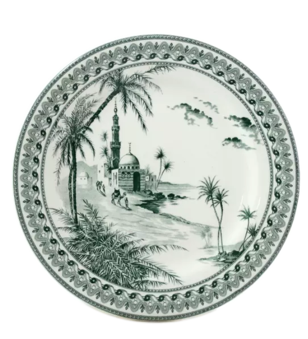 The Depareillees Vert Dinnerware and Serveware Collection by Gien France features a decorative ceramic plate with a monochrome landscape of palm trees, a mosque, people, and an ornate border—a unique accent for your table.
