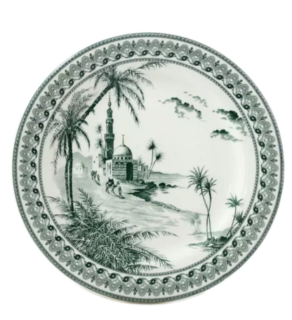 The Depareillees Vert Dinnerware and Serveware Collection by Gien France features a decorative ceramic plate with a monochrome landscape of palm trees, a mosque, people, and an ornate border—a unique accent for your table.