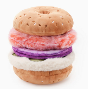 The Foggy Dog’s Bagel and Lox Interactive Dog Toy features soft, colorful layers like tomato, onion, lettuce, and cream cheese with crinkle and squeak sounds for extra playtime fun.