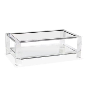 The Surrey Acrylic Rectangular Cocktail Table by Interlude Home features thick transparent acrylic legs, a glass top, and a lower glass shelf—an ideal choice to elevate any modern living room with contemporary flair.