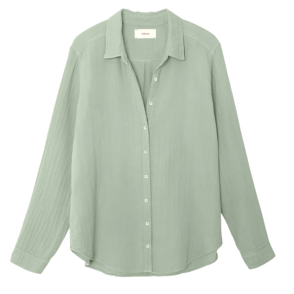 A light green Xirena Scout Shirt by Xirena, made from 100% cotton, featuring long sleeves and a button-up collar, shown against a plain white background.