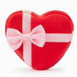 The Foggy Dog Be My Valentine Interactive Snuffle Dog Toy, a red heart-shaped plush with a pink ribbon and bow like a gift box, is the perfect Valentine’s Day present for your pup—shown here on a white background.