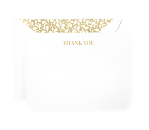 The Crane Gold Thank You Card Set features a white card with "THANK YOU" in gold and an open envelope with a Golden Swirls liner, all expertly crafted by Crane’s artisans.