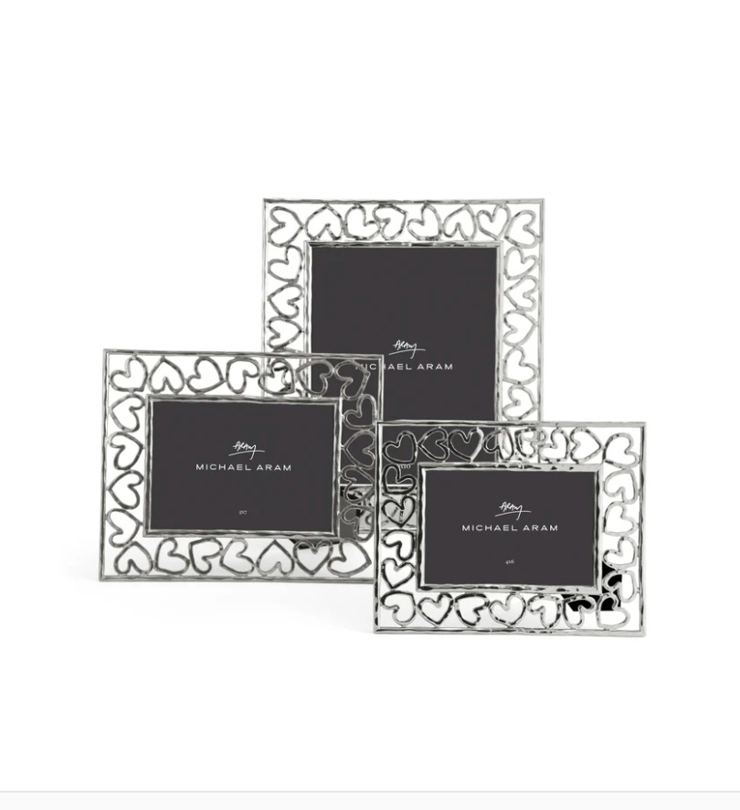 Three silver Heart Frames by Michael Aram feature hand-forged heart-shaped cutouts and a black placeholder marked "Michael Aram," symbolizing love and fine craftsmanship.