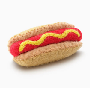 The Foggy Dog Hot Dog Cat Toy: a natural wool cat toy shaped like a felt hot dog with red sausage and yellow squiggle on a tan bun, shown on white background.