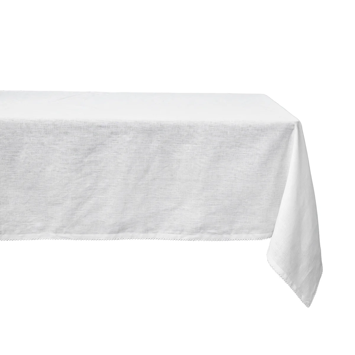 The Juliska Berry Scallop Tablecloth, crafted in Portugal, features elegant white linen that drapes gracefully over the table’s surface and edges.