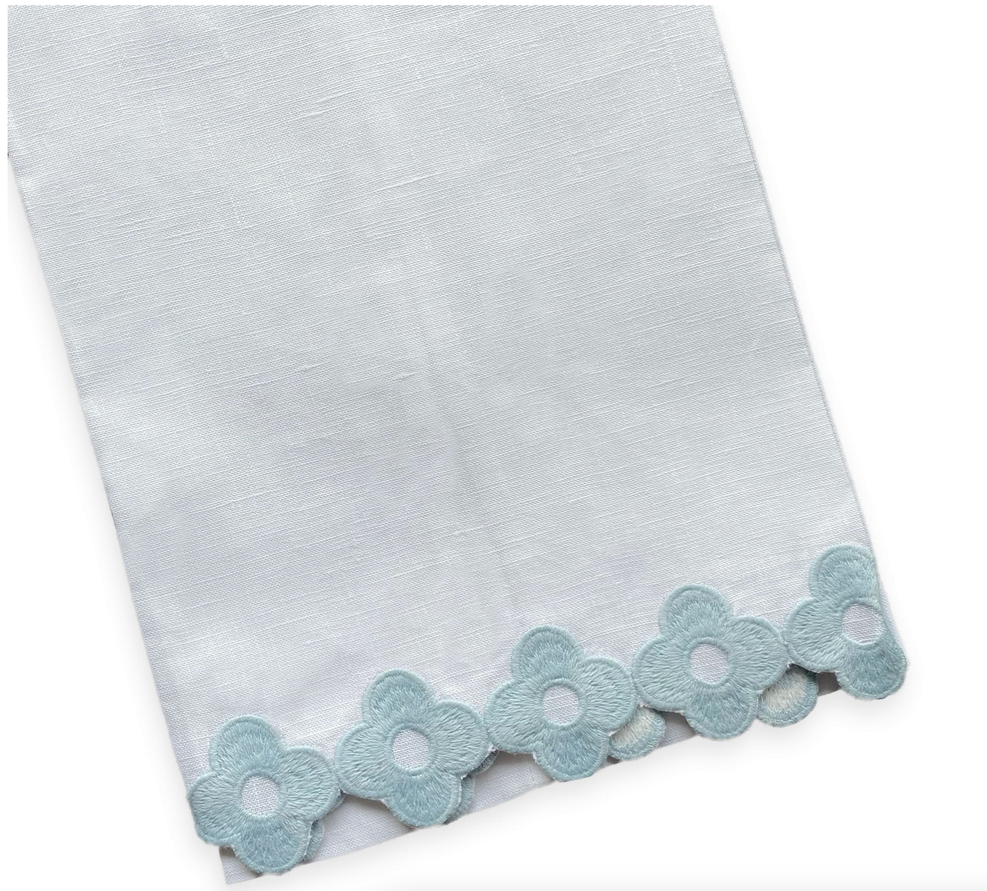 The Dolly Tip Towel, Blue by Haute Home is a stunning 14" x 20" white linen towel, adorned with delicate hand-embroidered light blue floral patterns that gracefully embellish the edges.