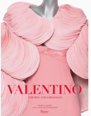 A mannequin adorned in an intricate pink dress with sculptural, layered ruffles embodies the artistry of high fashion. The accompanying text reads “Valentino: Themes & Variations” by Pamela Golbin, published by Rizzoli.