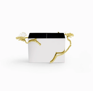 The Michael Aram Butterfly Gingko Gold Cutlery Holder is a rectangular white serveware piece with two compartments and decorative gold branch handles with leaf accents, inspired by the Butterfly Ginkgo sculpture.