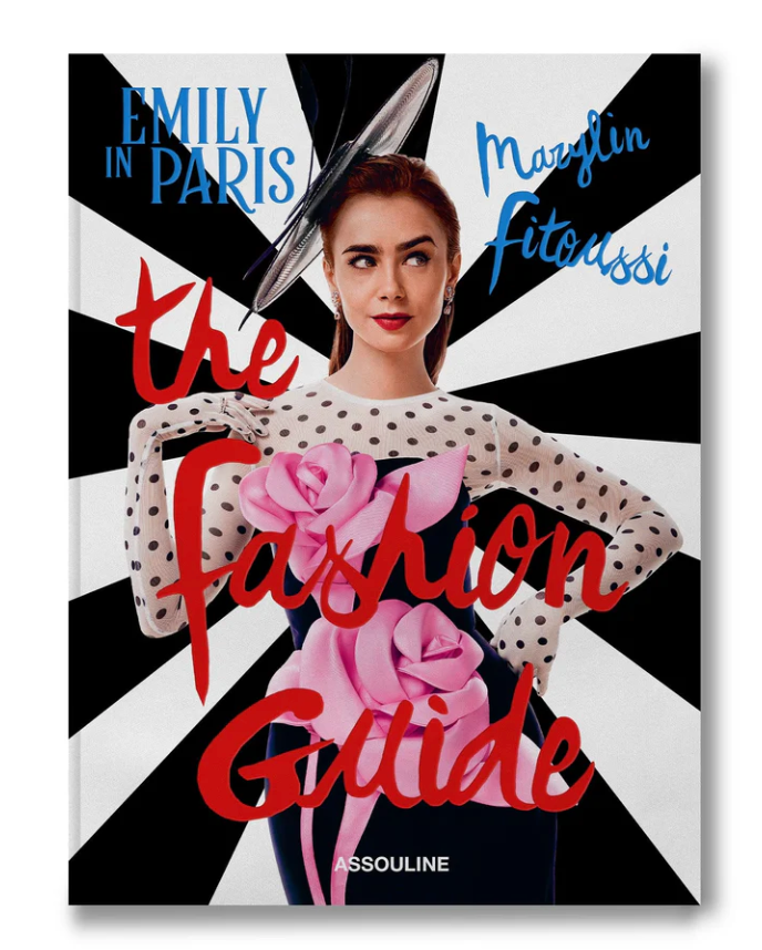 Book cover of Emily in Paris: The Fashion Guide by Assouline, showing Emily Cooper in a polka-dot top, floral details, and a large hat against a stylish black and white backdrop.