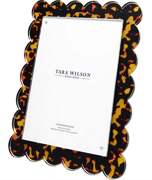 The Tortoise Scallop Frame, 8 x 10 by Tara Wilson Designs features a rectangular Lucite frame with scalloped edges and a tortoiseshell-patterned border.