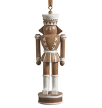 The Zodax Nutcracker Ornament features brown and white paint, a round base, and a hanging ribbon—ideal as festive holiday décor for your Christmas tree.
