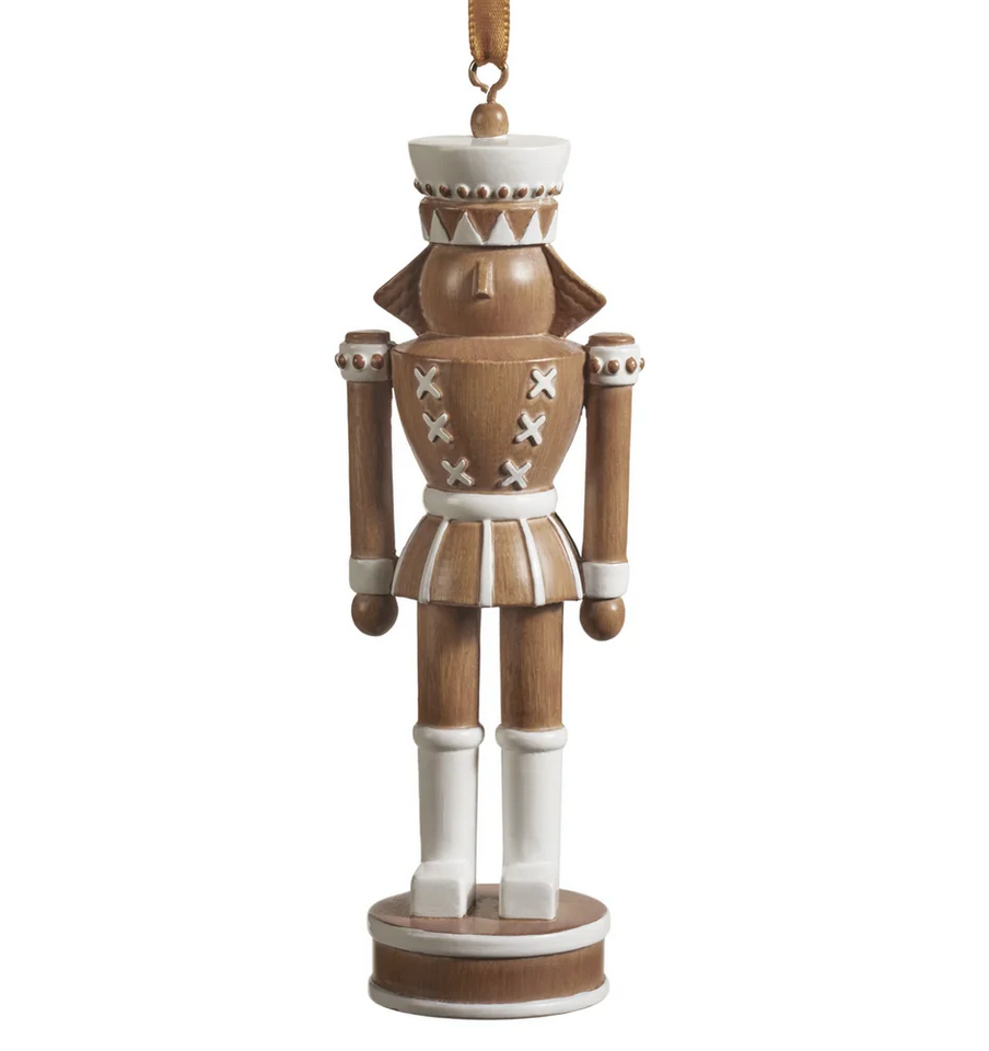 The Zodax Nutcracker Ornament features brown and white paint, a round base, and a hanging ribbon—ideal as festive holiday décor for your Christmas tree.