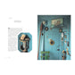 A blue wooden wall adorned with nautical accents—including a ship painting, mirrors, lanterns, and a green chair—inspires creative home decor. Evoking the charming look of eighteenth-century wallpaper, the space features text from *A Year in the French Style* by Penguin Random House about designing a serene sea chapel.