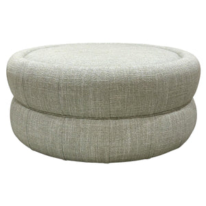 The Chloe Ottoman by Hickory Chair is a round ottoman with light gray upholstery, a smooth cushioned surface, and subtle stitched detailing.