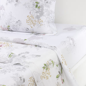 Experience comfort with the Yves Delorme Orchidee Bedding Collection, crafted from organic cotton sateen and showcasing subtle floral and leaf patterns in soft gray, green, yellow, and pink. Set includes pillowcase, sheet, and blanket.