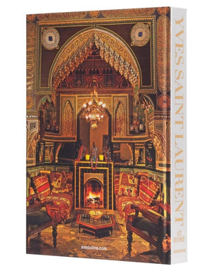 The book "Yves Saint Laurent at Home" by Assouline, features a cover with an ornately decorated room in warm tones and intricate patterns, showcasing the exquisite interior design mastery of Jacques Grange.