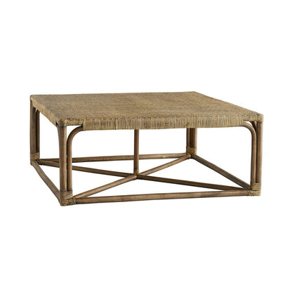 The Underhill Coffee Table by Arteriors showcases a woven herringbone rattan top and an open, geometric wooden base—an elegant natural rattan piece for any living space.