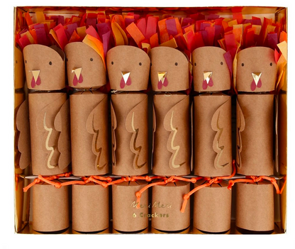 A box of six Meri Meri Turkey Party Crackers, each shaped like a turkey with orange, red, and yellow paper feathers and arranged in a single row—perfect party favors to bring festive charm to your Thanksgiving table.