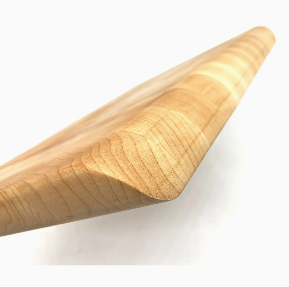 A close-up view of the J.K. Adams Infinity Edge Maple Cutting Board highlights its smooth, beveled edge and natural maple grain, providing a durable and stylish cutting surface.