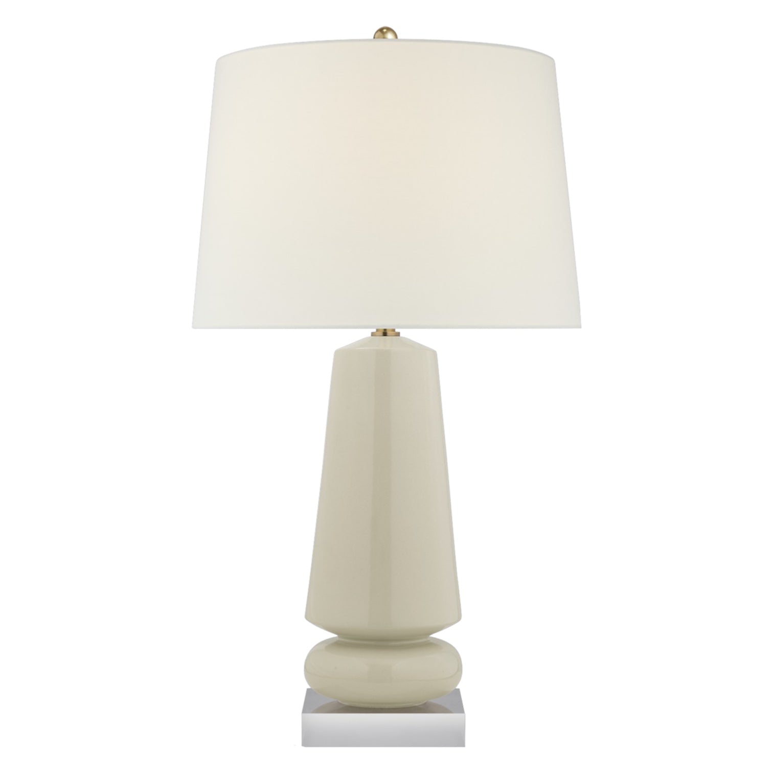 The Parisienne Medium Lamp in Coconut Porcelain by Visual Comfort features a geometric base with a reactive ceramic glaze and a large white lampshade, set on a small square metal platform.