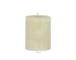A smooth, unlit ivory candle from Perin Mowen’s Solid Pillar Candle Collection stands upright with a visible wick; its hand-rolled finish and labeled 3" x 4" dimensions emphasize timeless elegance.