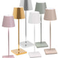 The Poldina Pro Lamp Collection by Zafferano America features six modern cordless lamps with slim square bases and conical shades in pastel and metallic pink, gold, silver, green, white, and beige—perfect for stylish illumination anywhere.