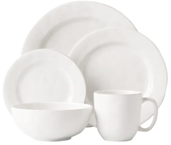 A set of Juliska Puro Whitewash Collection dinnerware, perfect for cocktail hour, includes two plates, a bowl, and a mug displayed against a neutral palette background.