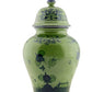 A green ceramic lidded vase from the Oriente Italiano Malachite Dinnerware & Decor Collection by Ginori 1735, featuring dark blue floral and landscape designs, shown on a white background.