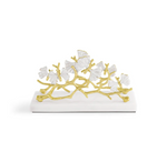 The Michael Aram Butterfly Gingko Gold Vertical Napkin Holder features gold branches and white ginkgo leaves, making it a stylish and elegant addition to your table décor.