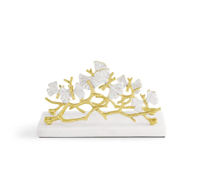 The Michael Aram Butterfly Gingko Gold Vertical Napkin Holder features gold branches and white ginkgo leaves, making it a stylish and elegant addition to your table décor.