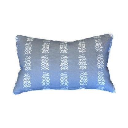 The Petite Frond Blue Lumbar Pillow by Hive Custom Pillows features white vertical leaf-like patterns on a rectangular blue background, shown against a plain white backdrop.