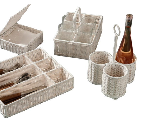 Blue Pheasant Micaela White Rattan serving trays and holders with utensils and a bottle of wine on a marbled background.