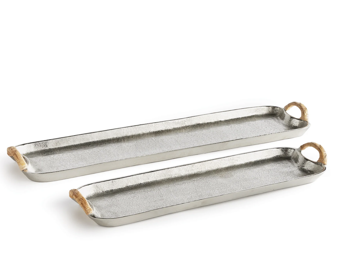 The Helena Long Tray Collection by Napa Home & Garden features two cast aluminum trays with rattan-wrapped handles and raised edges, displayed side by side on a white background for a stylish designer look.