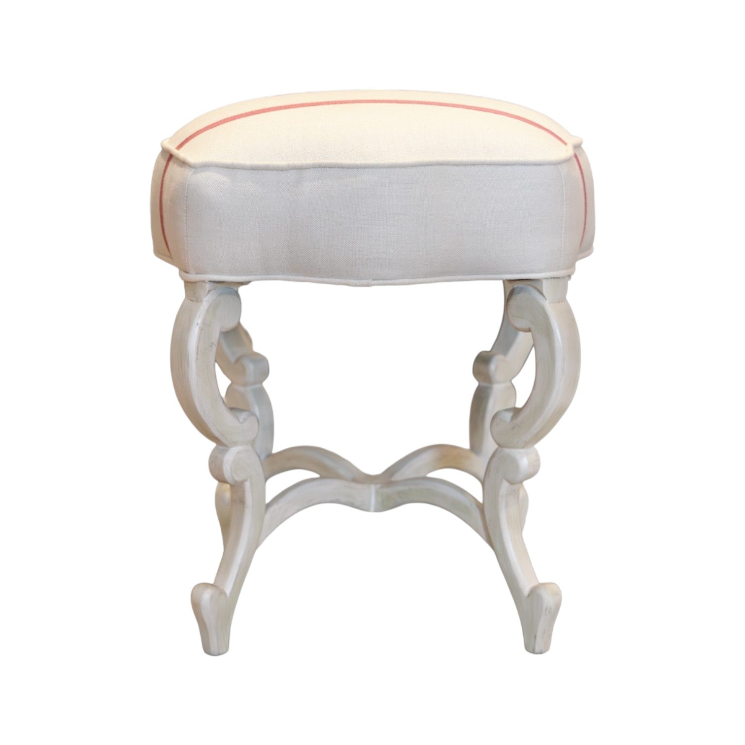 The Anastasia Bench by Hickory Chair is a white wooden stool with curved legs and a cushioned, off-white seat accented with subtle pink piping, shown against a white background.
