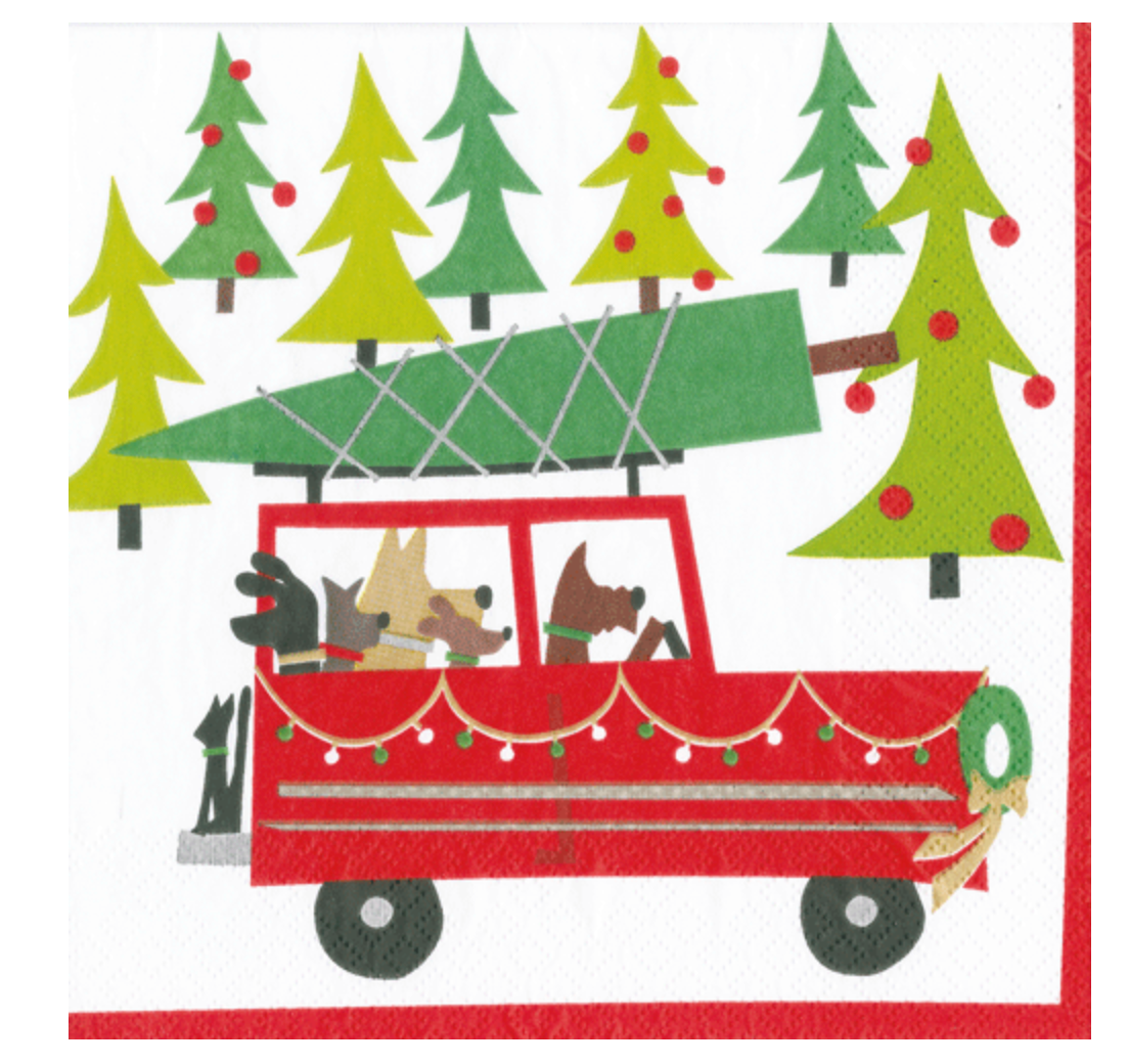 The Caspari Doggy Tree Adventure Cocktail Napkin features a red car with three dogs and a Christmas tree, driving through a snowy forest—beautifully printed on triple-ply napkins with nontoxic dyes.