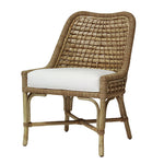The Capitola Side Chair by PALECEK, part of the Capitola collection, has a woven rattan design and a white cushioned seat. Its sturdy rattan frame pairs with wooden legs in a natural finish, making it an elegant focal point for any room.