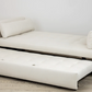 A Day Bed in Laguna Cloud Crypton by Lee Industries, featuring a pull-out trundle, elegantly complements the room's dimensions as it rests on a light wood floor.