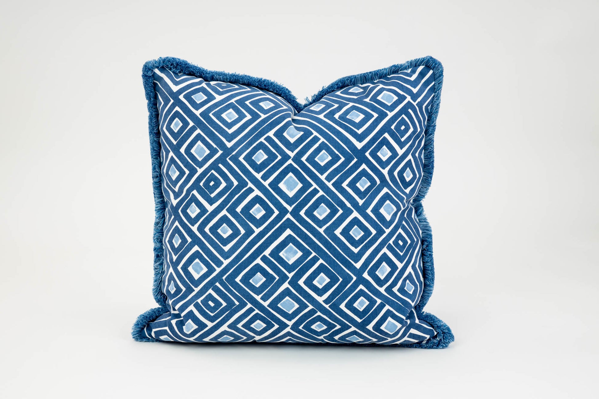 An Indigo Labyrinth Outdoor Pillow with a contrast trim, handmade in the USA by Edgar Custom Drapery.