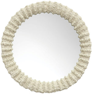 The Antigua Mirror by PALECEK is a round mirror with a textured, woven-look frame in off-white, adding a touch of unique elegance.