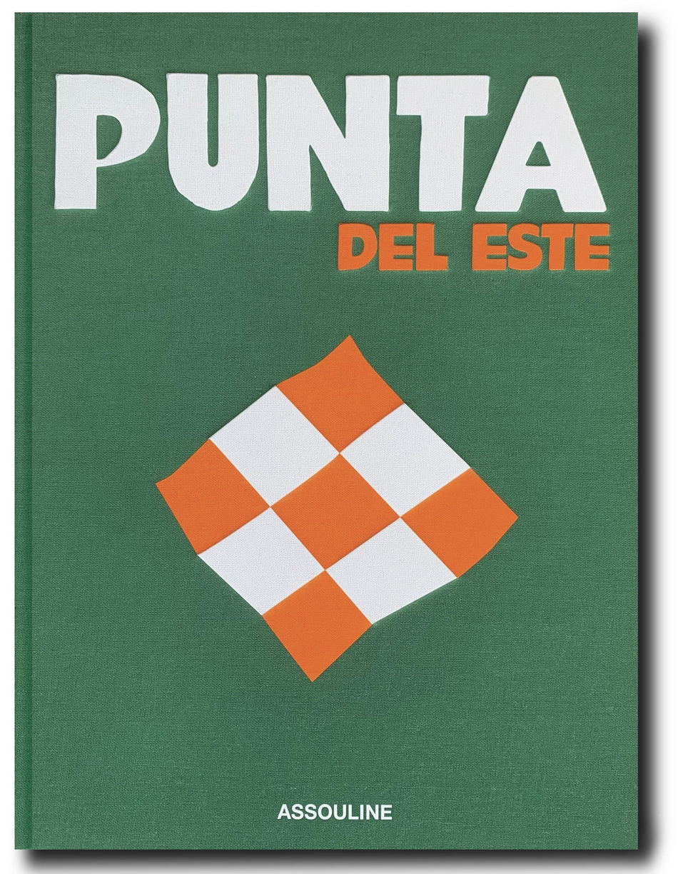 A green and white sign with orange squares in Assouline's Punta del Este.