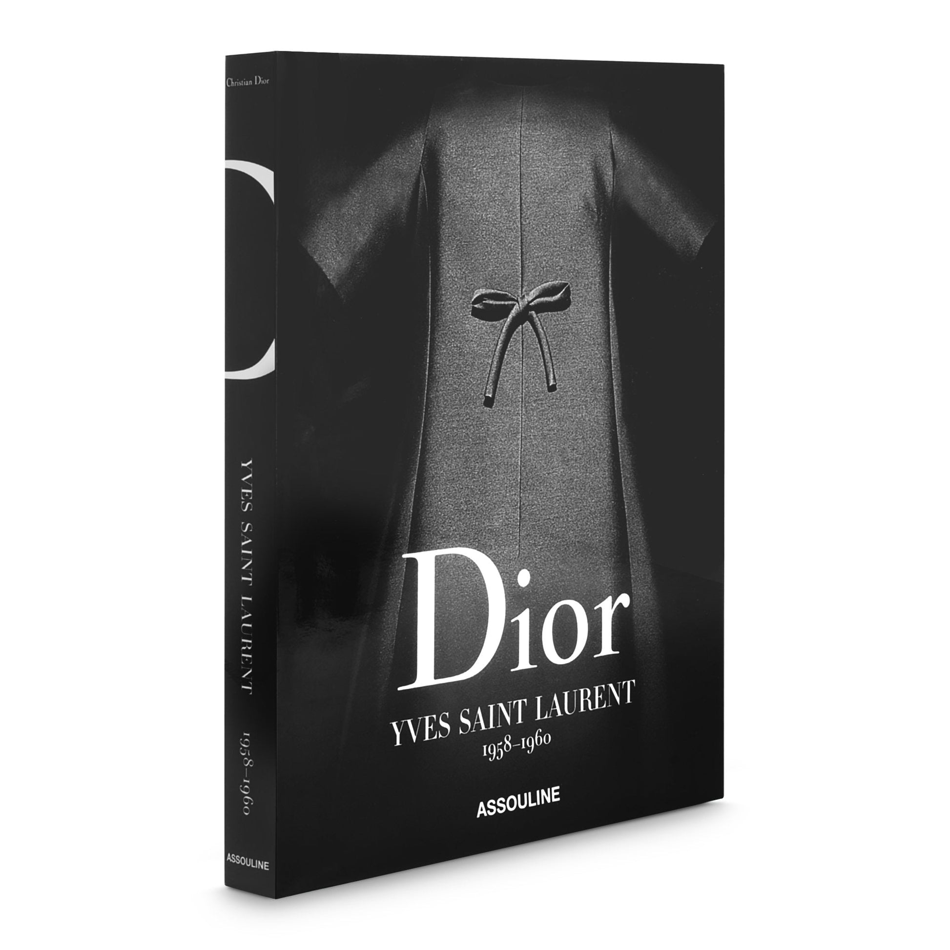 A hardcover book titled "Dior II by YSL" by Assouline, displaying a black and white image of a bow-adorned dress on the cover, capturing the essence of haute couture.