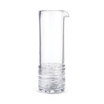 The Simon Pearce Echo Lake Cocktail Carafe, a tall clear glass vessel with a narrow spout and textured base, stands against a plain white background, perfect for serving refreshing cocktails or classic martinis.