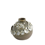 The Flat Sea Sage Coral Small Vase by Global Views features a round ceramic form with a narrow neck and metallic disc accents on the upper half. Its watertight design makes it perfect for fresh flowers and an ideal centerpiece for any space.