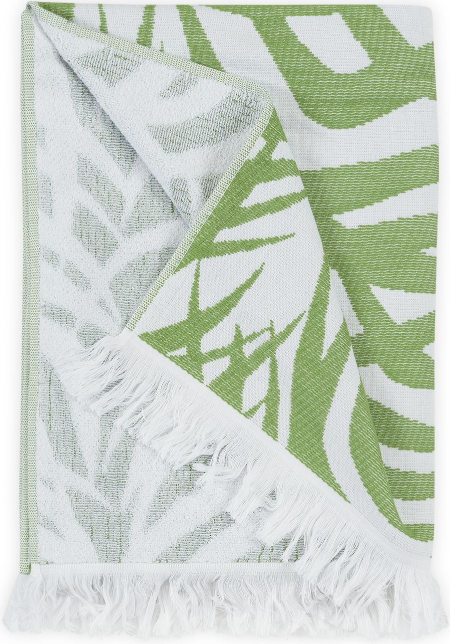 The Matouk Zebra Palm Beach Towel, Jungle features a green and white tropical leaves design, cotton terry texture, and white fringe edges.