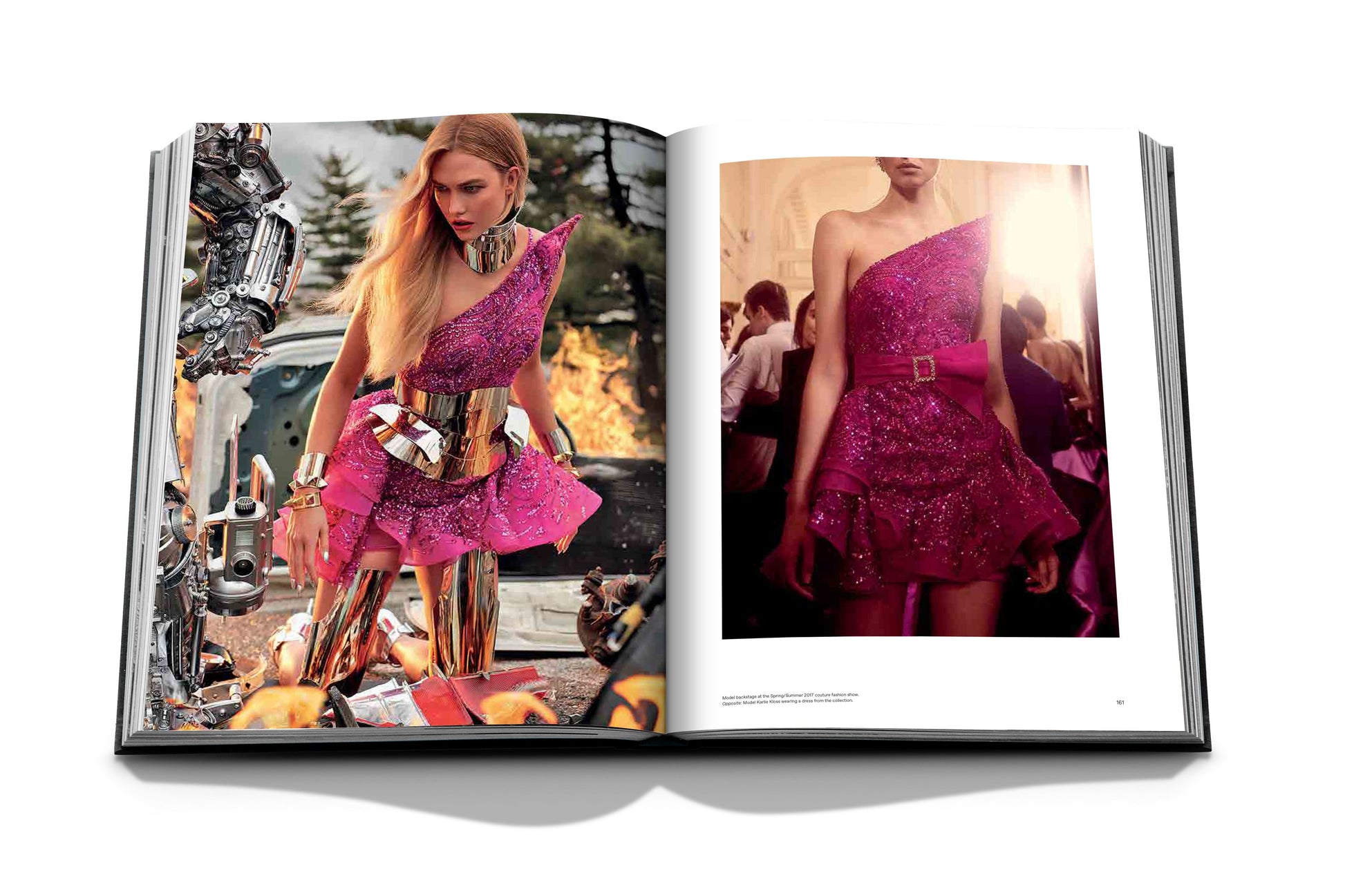 An open book showcases the captivating couture collections from Assouline, featuring a model in a vibrant pink, one-shoulder dress by Zuhair Murad, adorned with metallic elements across various settings.