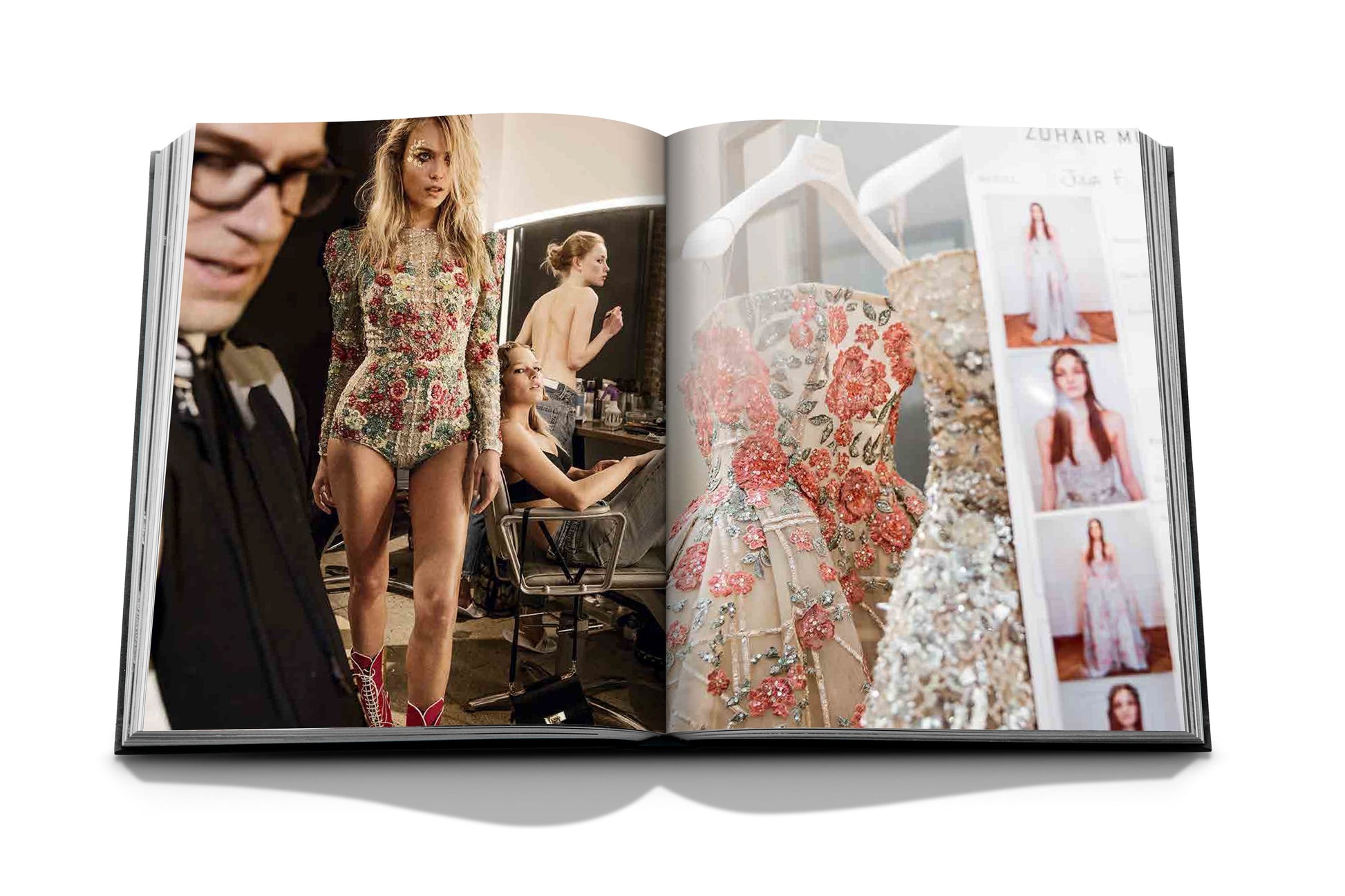 An open fashion magazine features backstage images of models adorned in Zuhair Murad's dresses, highlighted by Assouline, showcasing exquisite handcrafted beading.