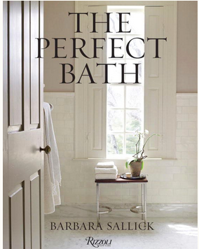 Book cover of "The Perfect Bath" by Rizzoli shows a bright bathroom scene with a towel rack, stool with stacked towels, and a potted orchid by the window—inviting you to envision your dream bath design.